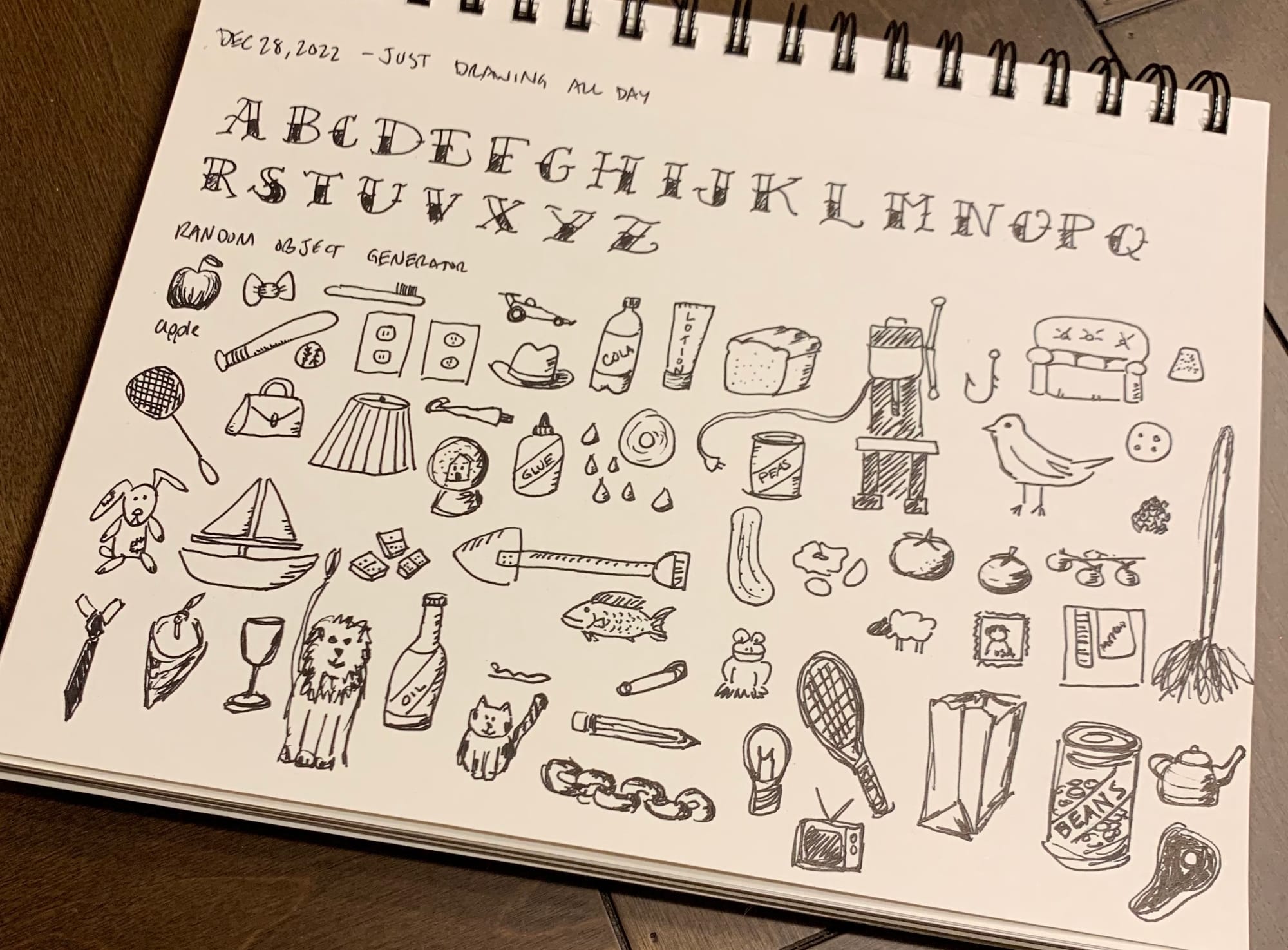 My sketchbook with a series of drawn objects and practice writing using an old-school tattoo typeface.